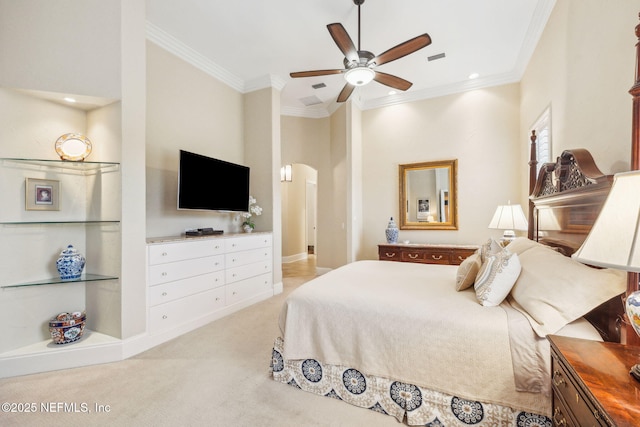 carpeted bedroom with ornamental molding and ceiling fan