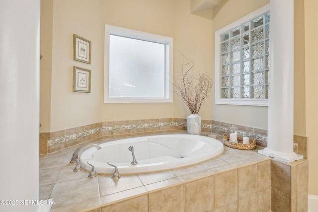 bathroom with plenty of natural light and tiled bath