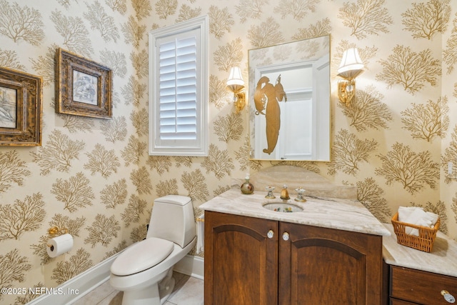 bathroom with vanity, tile patterned floors, and toilet