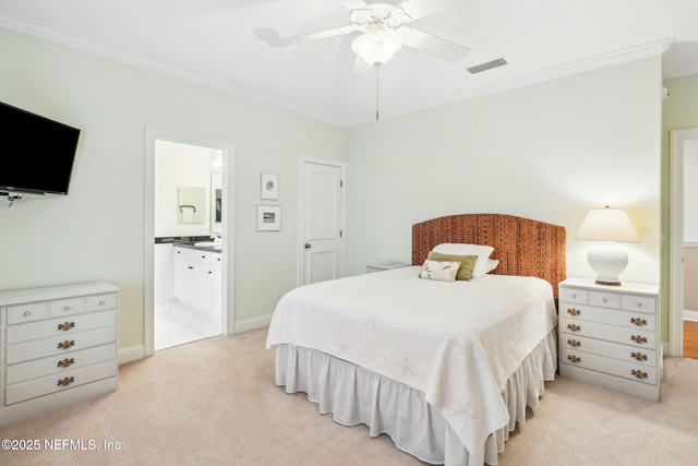 bedroom featuring ornamental molding, connected bathroom, light colored carpet, and ceiling fan