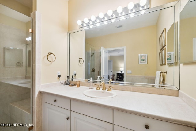 bathroom with vanity and a shower with door