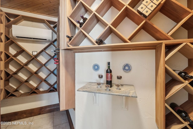 wine area featuring dark tile patterned flooring and a wall mounted AC