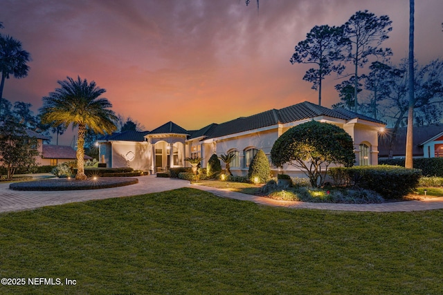 mediterranean / spanish house with a lawn