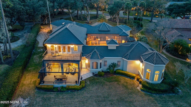 exterior space with a balcony and a front yard