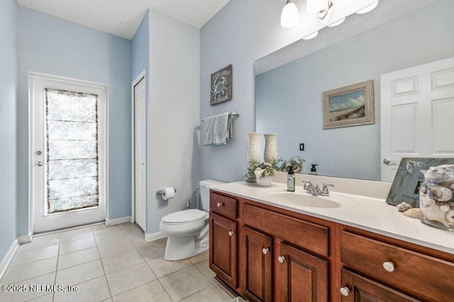 bathroom with vanity, tile patterned floors, and toilet