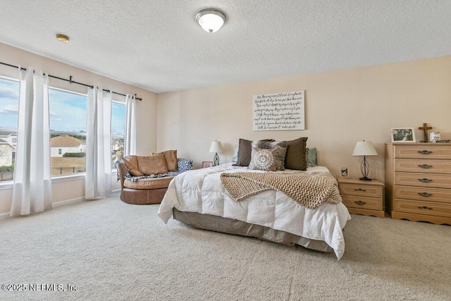 carpeted bedroom featuring a textured ceiling