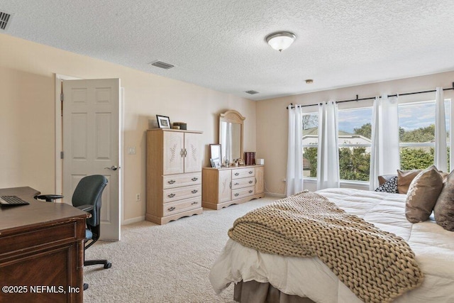 carpeted bedroom featuring a textured ceiling