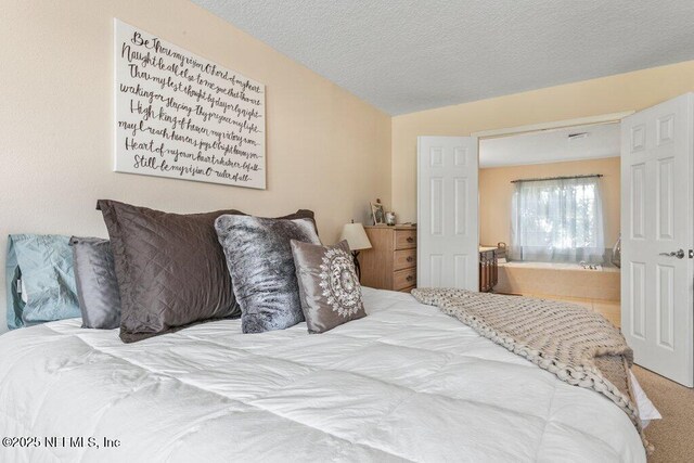 bedroom featuring carpet flooring and a textured ceiling