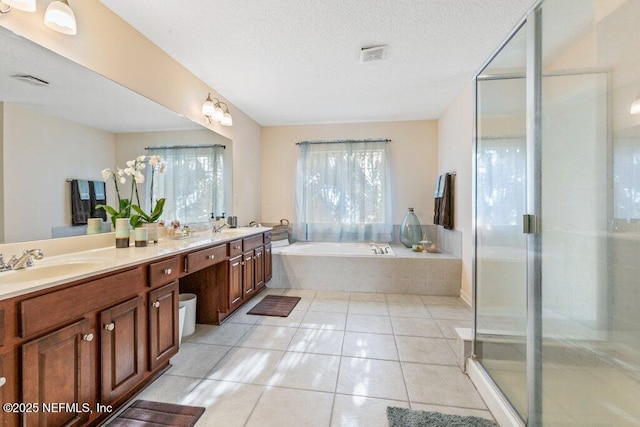 bathroom featuring vanity, tile patterned floors, independent shower and bath, and a textured ceiling