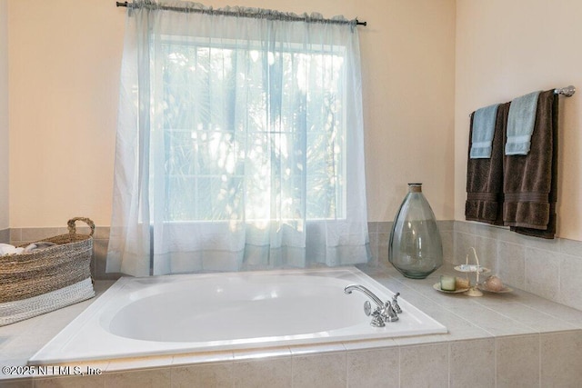 bathroom with a relaxing tiled tub