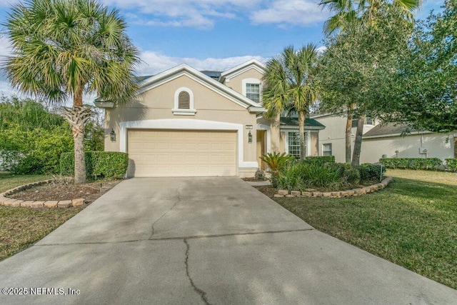 view of front of house featuring a garage and a front yard