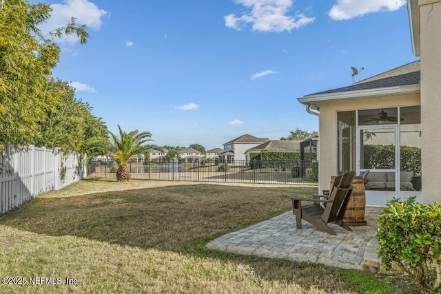 view of yard featuring ceiling fan and a patio area