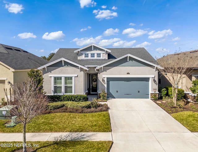 view of front of house with a garage and a front yard