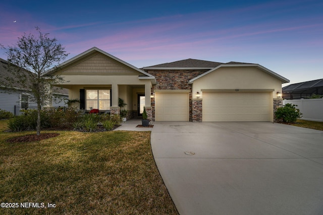 view of front facade featuring a garage and a lawn