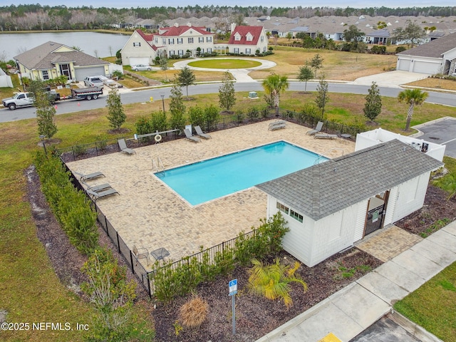 view of swimming pool featuring a patio and a water view