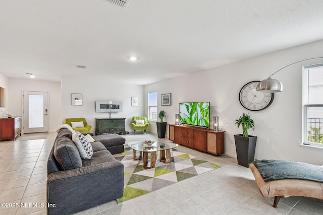 living room with light tile patterned floors and a healthy amount of sunlight