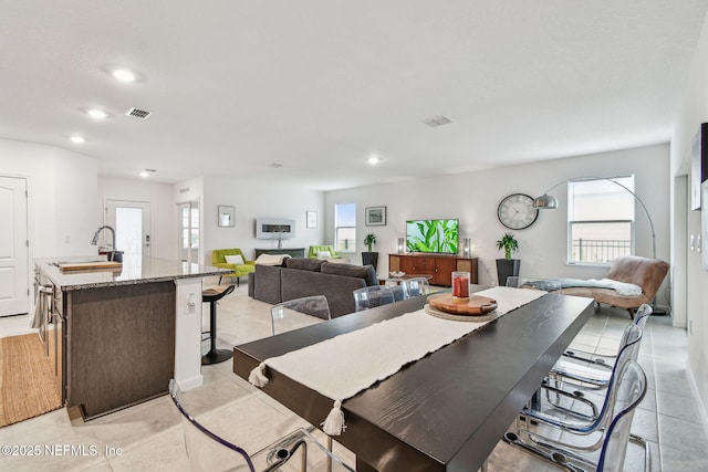 dining area with sink and light tile patterned floors