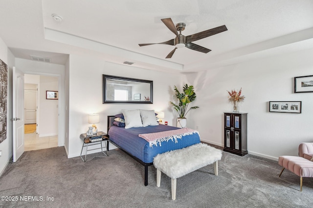 bedroom featuring ceiling fan, carpet flooring, and a raised ceiling