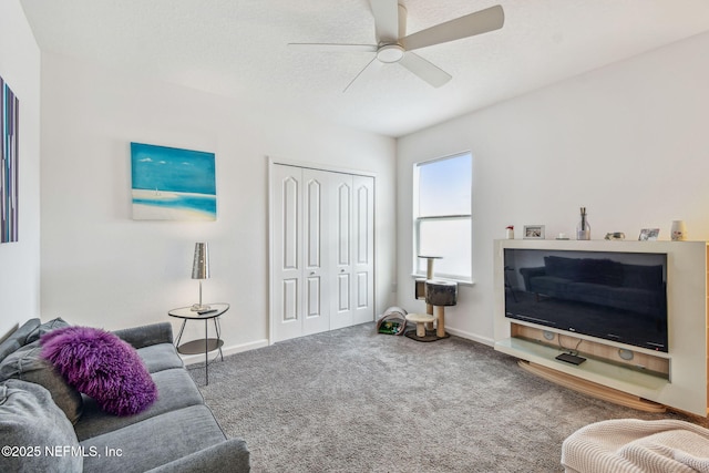 carpeted living room with ceiling fan