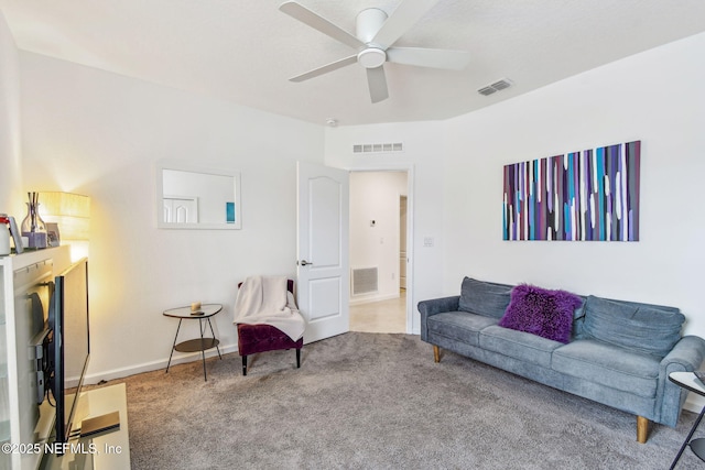 carpeted living room with ceiling fan