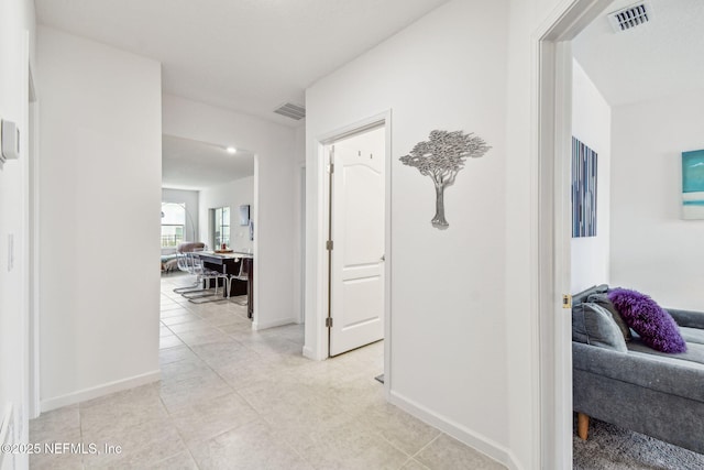 hall featuring light tile patterned floors