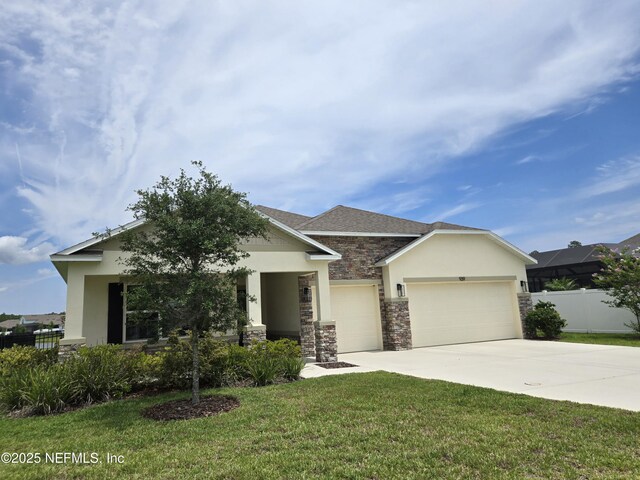 939 Ocean Jasper Dr, Saint Augustine, FL 32086 - view of front of property with stone siding, a garage, concrete driveway, and stucco siding