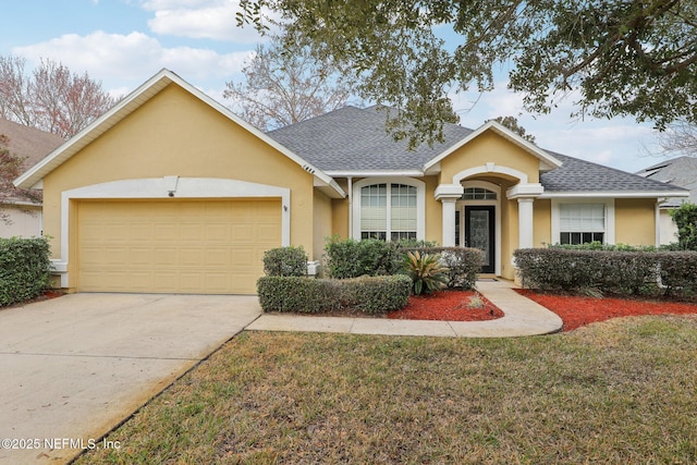 single story home featuring a garage and a front lawn