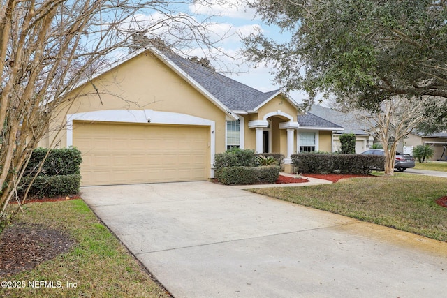 ranch-style house featuring a garage and a front yard