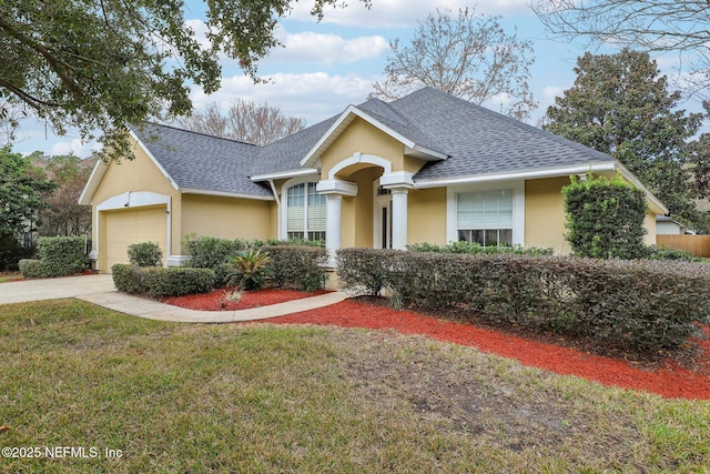 ranch-style house featuring a garage and a front lawn