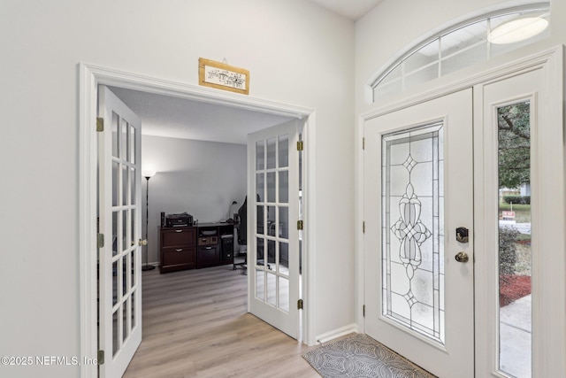 foyer with french doors and light wood-type flooring