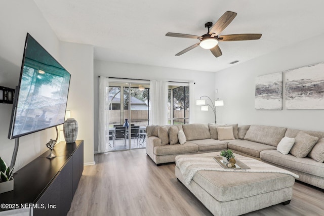 living room with hardwood / wood-style flooring and ceiling fan