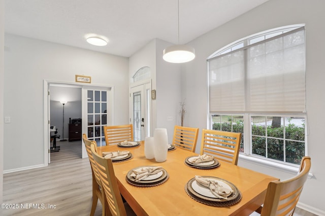 dining room featuring light hardwood / wood-style floors and french doors