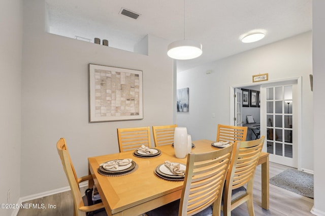 dining area with wood-type flooring