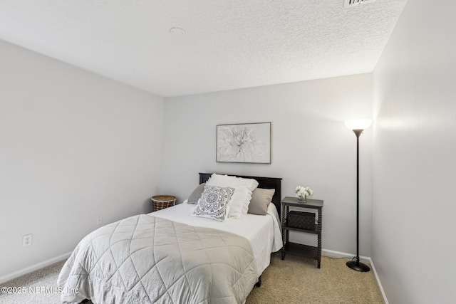 carpeted bedroom featuring a textured ceiling