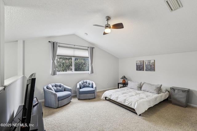 carpeted bedroom featuring lofted ceiling, ceiling fan, and a textured ceiling