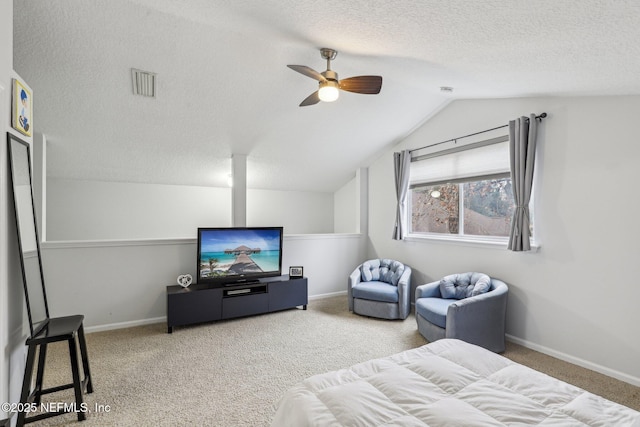 bedroom with vaulted ceiling, carpet floors, and a textured ceiling