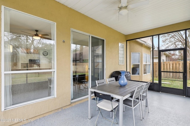 sunroom / solarium featuring ceiling fan and a healthy amount of sunlight