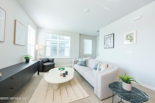 living room with plenty of natural light and light wood-type flooring