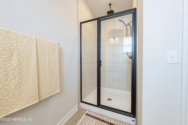 bathroom featuring a shower with shower door