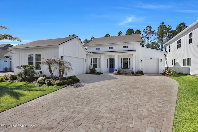 view of front of property featuring a garage and a front lawn