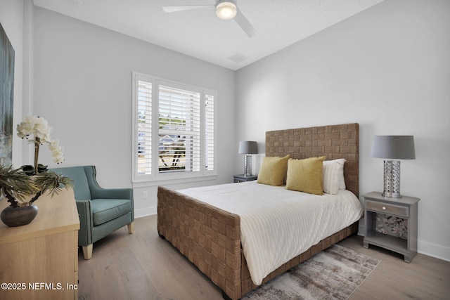 bedroom featuring ceiling fan, lofted ceiling, and light hardwood / wood-style floors