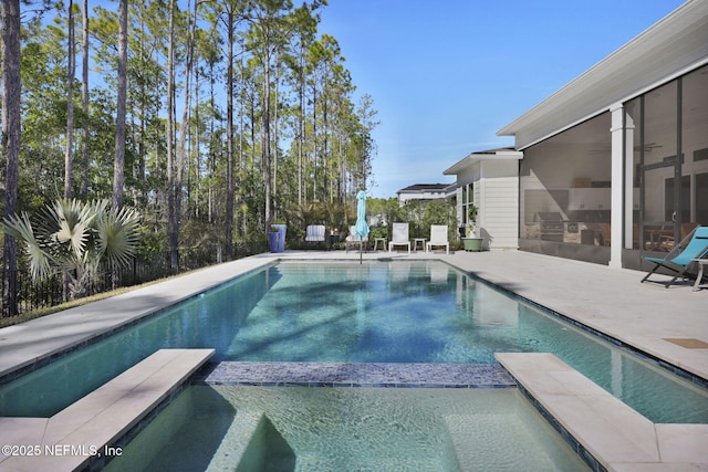 view of pool featuring ceiling fan and a patio area