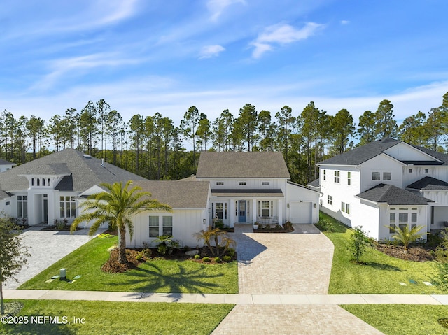 view of front of property with a front lawn and a garage