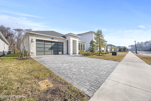 view of front of property featuring a garage and a front lawn