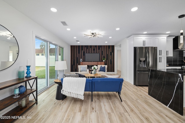 living room with light hardwood / wood-style flooring