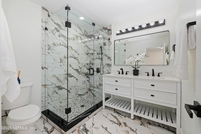 bathroom with walk in shower, vanity, and toilet