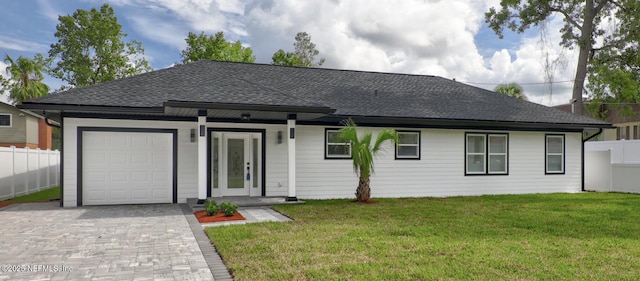 ranch-style house featuring a garage and a front yard