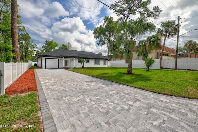 view of front of property with a garage and a front yard