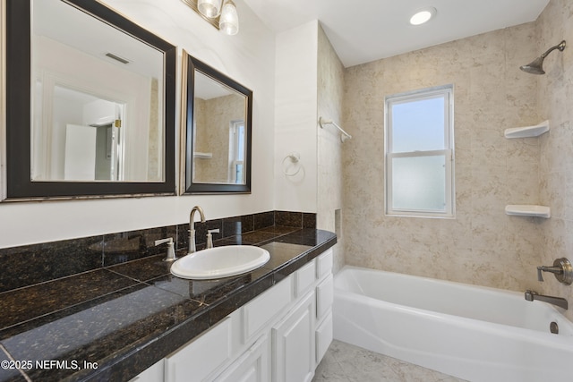 bathroom featuring vanity and tiled shower / bath combo