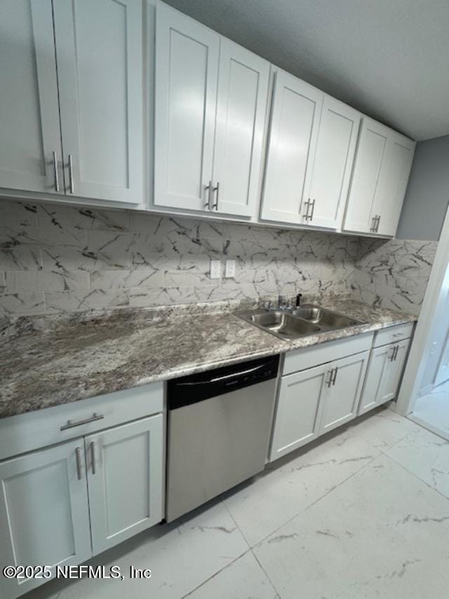 kitchen with sink, white cabinetry, dishwasher, dark stone counters, and decorative backsplash